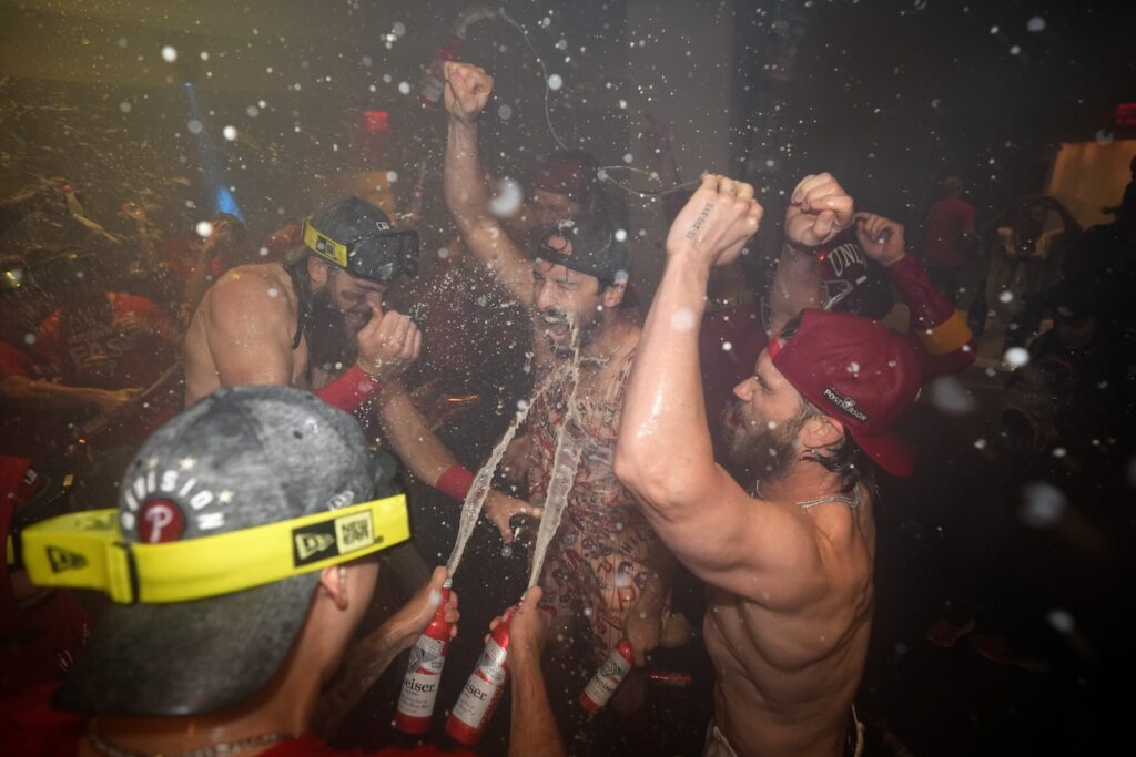 Cubs Phillies Baseball Philadelphia Phillies' Brandon Marsh, from left, Garrett Stubbs and Bryce Harper celebrate after the Phillies won a baseball game against the Chicago Cubs to clinch the NL East title, Monday, Sept. 23, 2024, in Philadelphia.