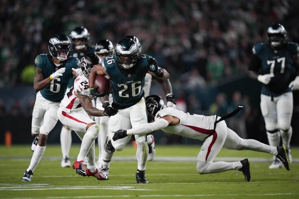 Falcons Eagles Football Philadelphia Eagles running back Saquon Barkley runs with the ball under pressure from Atlanta Falcons cornerback A.J. Terrell and safety Jessie Bates III during the second half on Monday, Sept. 16, 2024, in Philadelphia