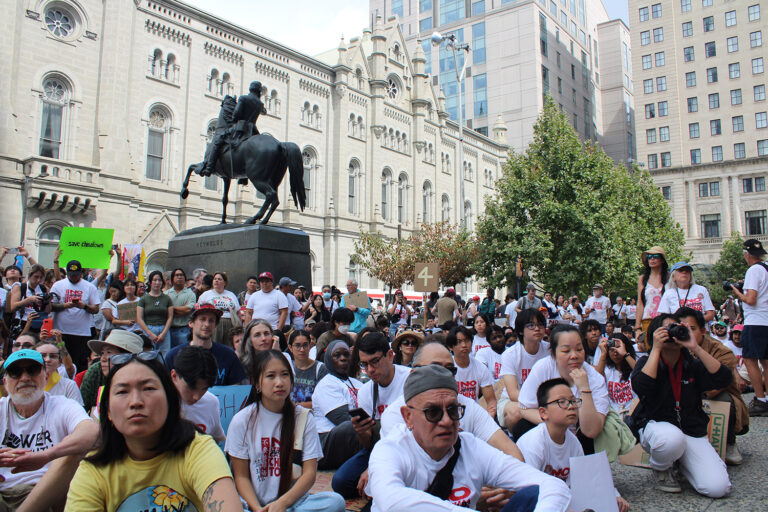 People sit and protest 76er place in Philadelphia's Chinatown neighborhood
