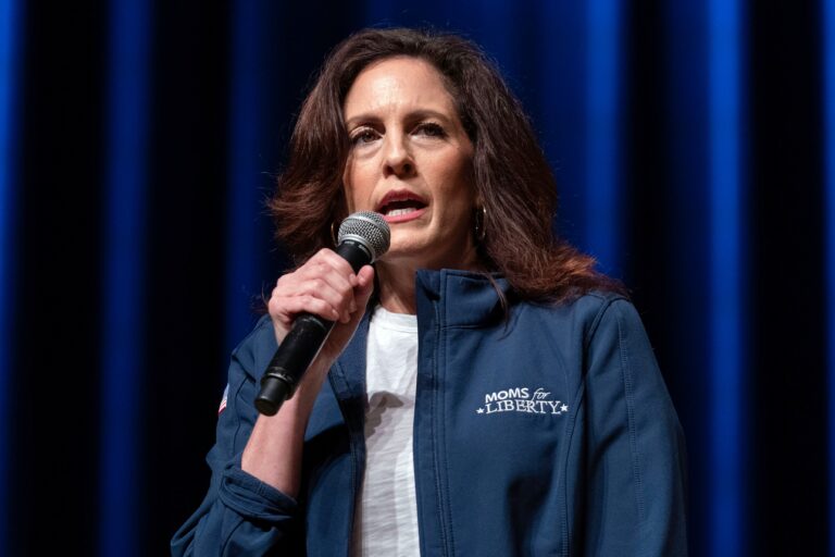 Tiffany Justice speaks into a microphone