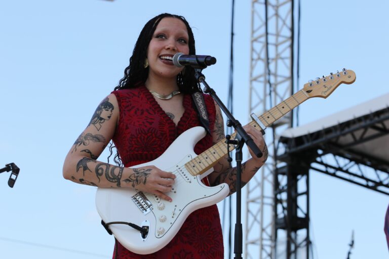 Julia Pratt playing guitar and singing