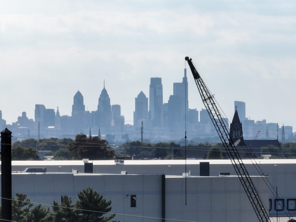 A crane juxtaposed with the Philadelphia skyline. (Emma Lee/WHYY) A crane juxtaposed with the Philadelphia skyline