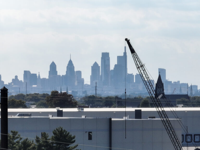 A crane juxtaposed with the Philadelphia skyline