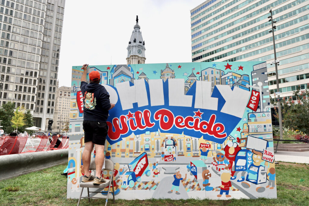 2024 10 01-e lee-hawk krall-philadelphia love park-to the polls murals Man details a mural that reads