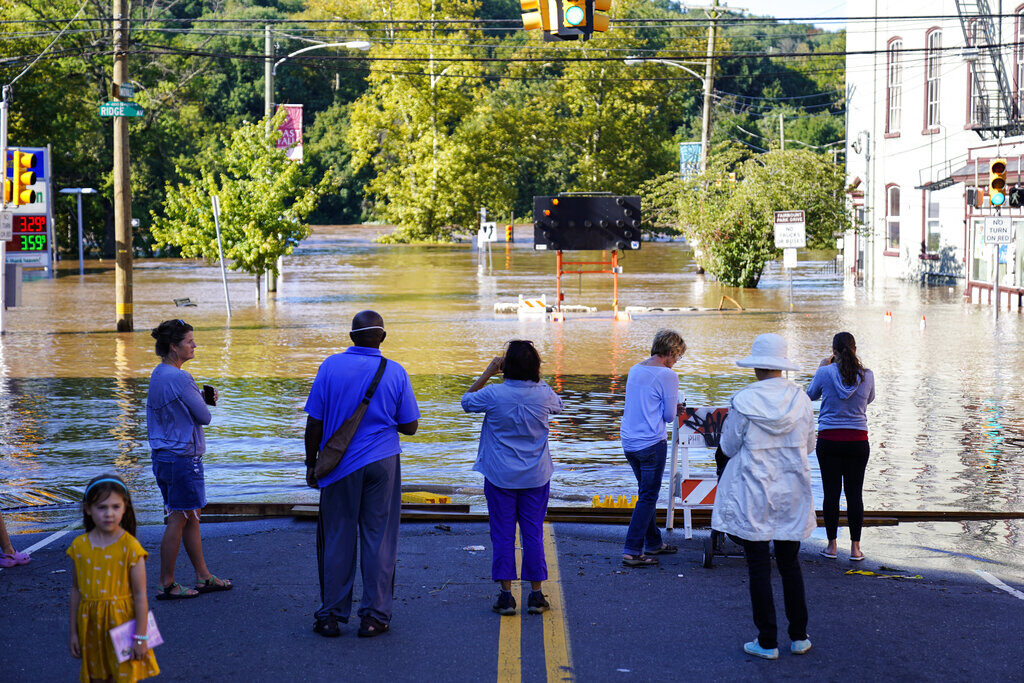 People look at a flooded street