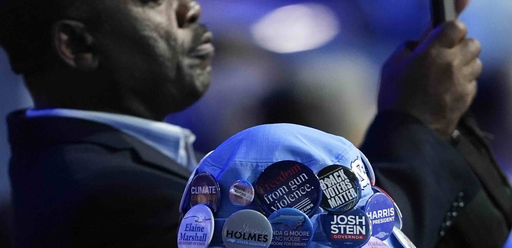 Delegates take photos during the Democratic National Convention Monday, Aug. 19, 2024, in Chicago. (AP Photo/Charles Rex Arbogast)