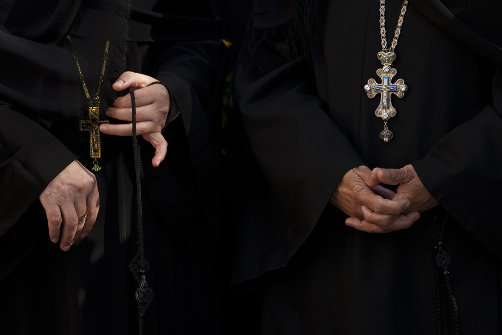 Nuns attend the procession of Saint Dimitrie Bassarabov, the patron saint of the Romanian capital, in Bucharest, Romania, Thursday, Oct. 24, 2024. (AP Photo/Andreea Alexandru)