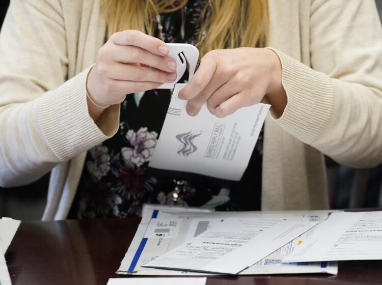 An election worker canvasses ballots