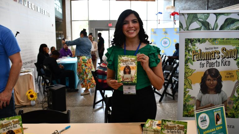 Author Adriana Erin Rivera at a booth