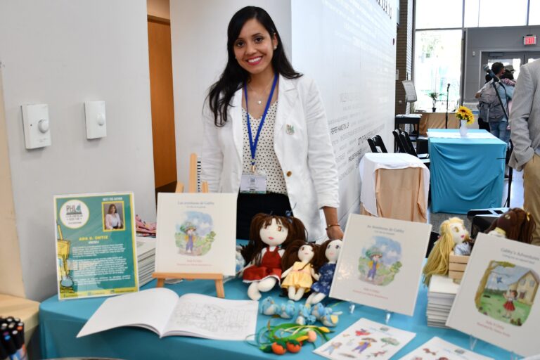 Author Ada S. Ortiz at a booth