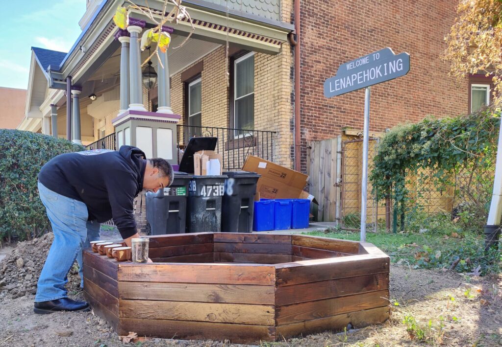 Tim Martin adds dirt to the raised bed
