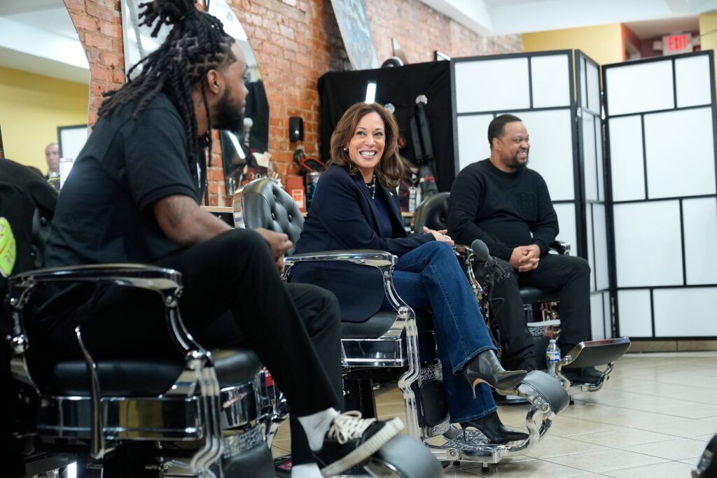 kamala-harris-2024-10-27-barbershop-1 Kamala Harris sits and smiles at a barbershop