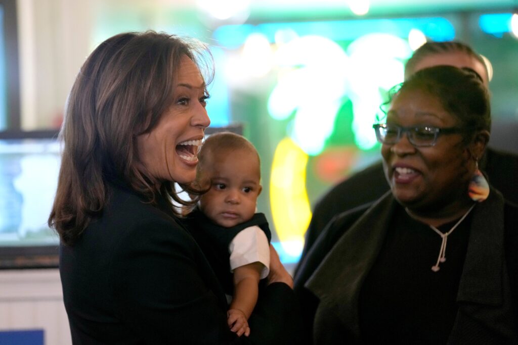 Kamala Harris holds a baby