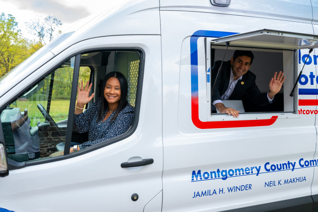 montco-mobile-voter-services-2 Commissioners Jamila Winder, left, and Neil Makhija, right, pose with Montgomery County's new voter services van.