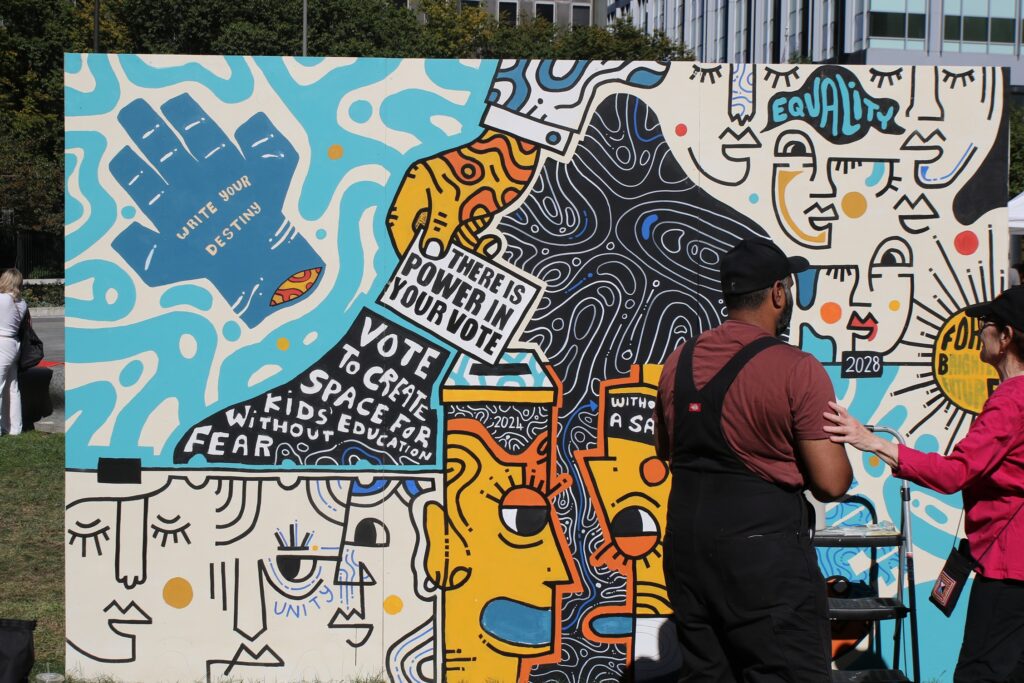 mural-arts-festival-2024-10-06-13 two artists working on a mural