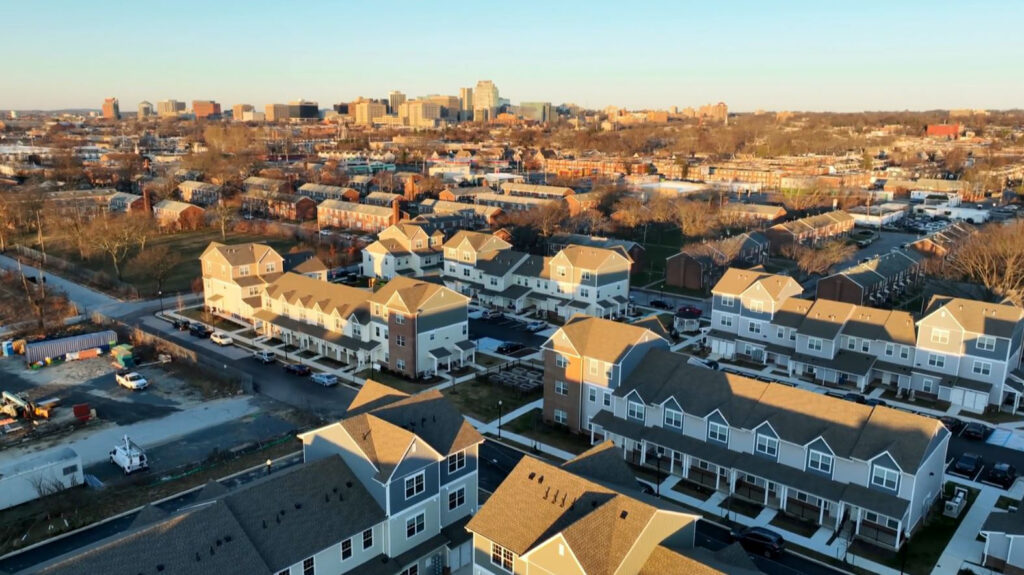 resurrect-riverside-01-169-city-skyline-looms-in-background Aerial view of Imani Village