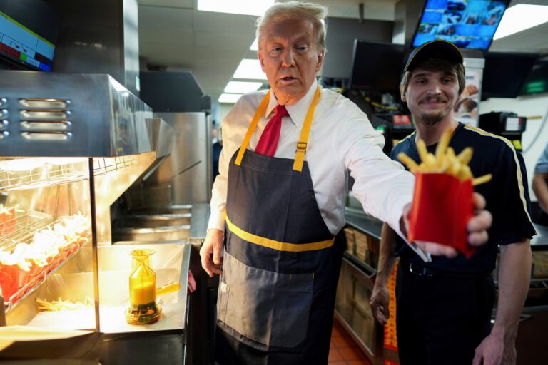 Donald Trump hands a customer fries