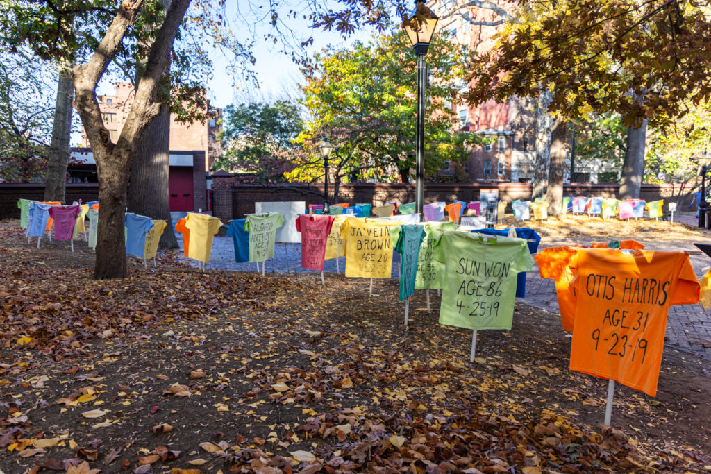 11 08 2024 k paynter memorial to the lost arch street meetinghouse-2 t-shirts on stakes throughout the outside of the Meetinghouse