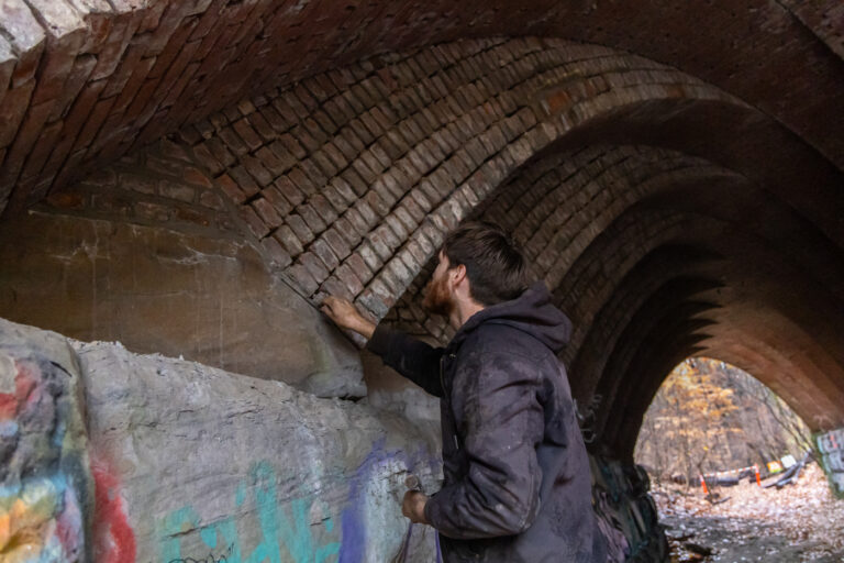 Andrew Staples adds mortar to the bridge