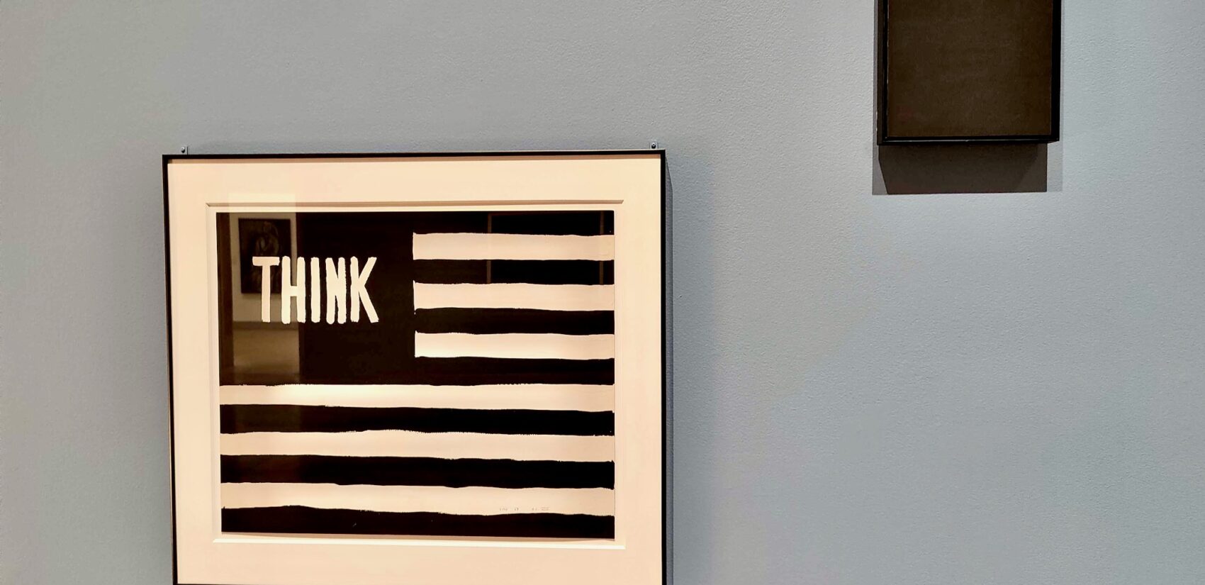 Wilson Nelson Copley's ''Untitled (Think)'' (1967) and Ad Reinhardt's ''Black Cross'' from the same year, are paired in ''What Times are These?'' at the Philadelphia Museum of Art. (Peter Crimmins/WHYY)
