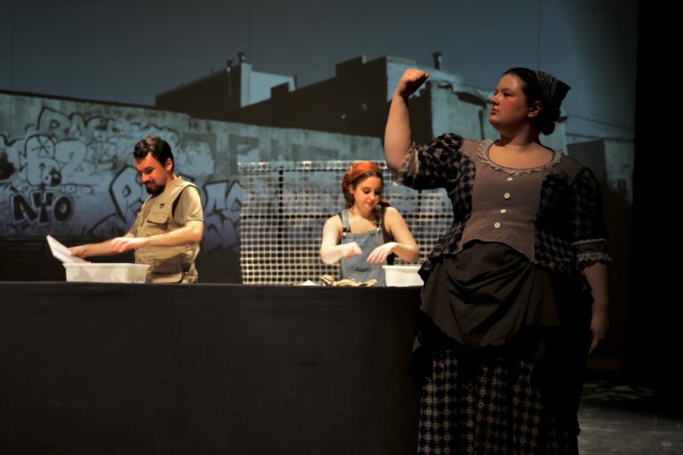 During a rehearsal for ''Alice Tierney,'' one of three versions of Alice, portrayed by West Chester University student Anastasia Groden, makes a gesture as archaeologists behind her sift through artifacts discovered at the site of her murder. (Emma Lee/WHYY)