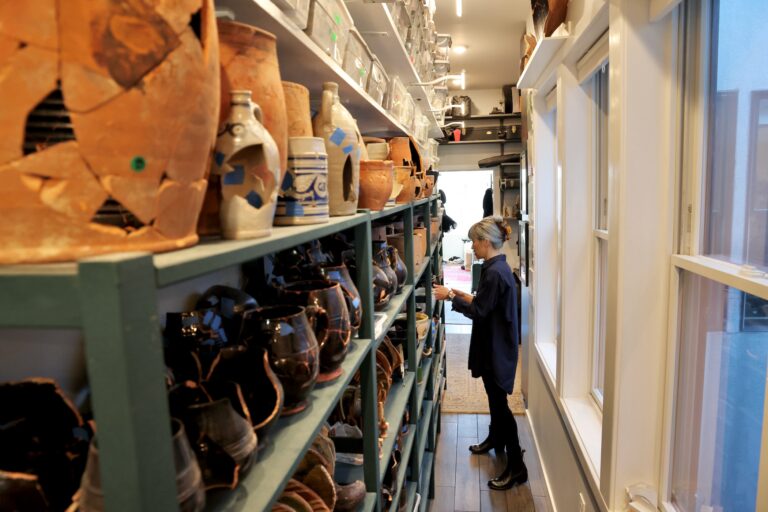 Since discovering two pre-Civil War privy pits beneath her home on Callowhill Street, Melissa Dunphy has amassed thousands of pieces of pottery and other artifacts. (Emma Lee/WHYY)