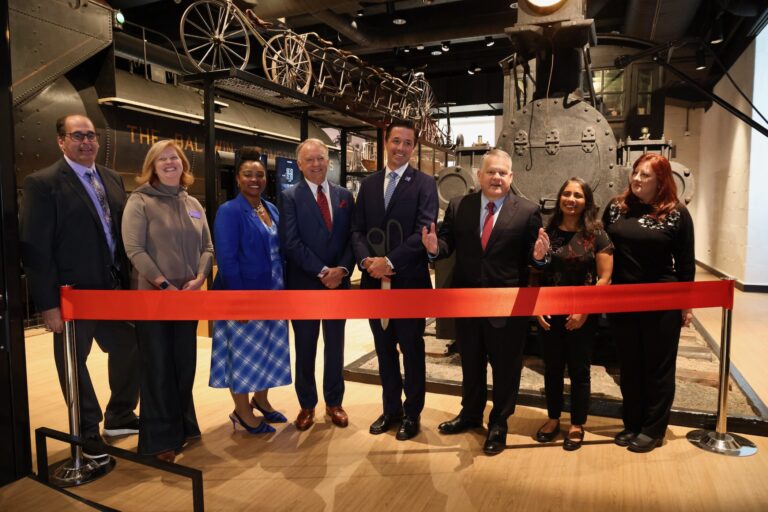 People wait to cut the ribbon