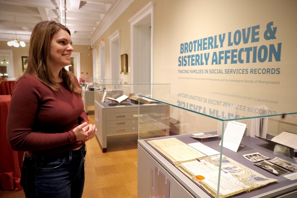 2024 11 21-e lee-katy bodenhorn barnes-philadelphia historical society-social services exhibit curator Katy Bodenhorn Barnes looking at items in the exhibit