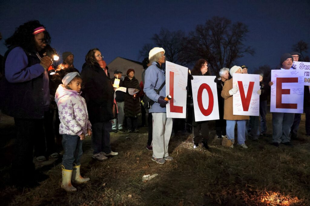 2024 11 23-e lee-lawnside nj-vigil racist graffiti love Lawnside residents look on and four signs read LOVE
