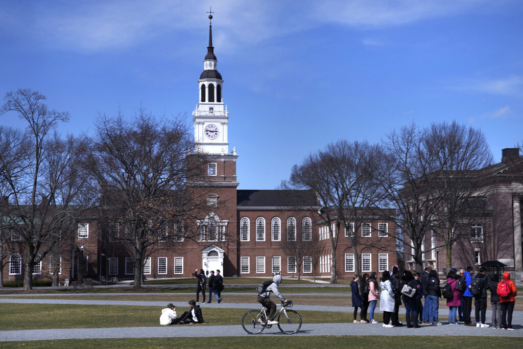 Dartmouth Student Death FILE - A bicyclist passes a college tour group outside the Baker Library at Dartmouth College, April 7, 2023, in Hanover, N.H. (AP Photo/Charles Krupa, File)