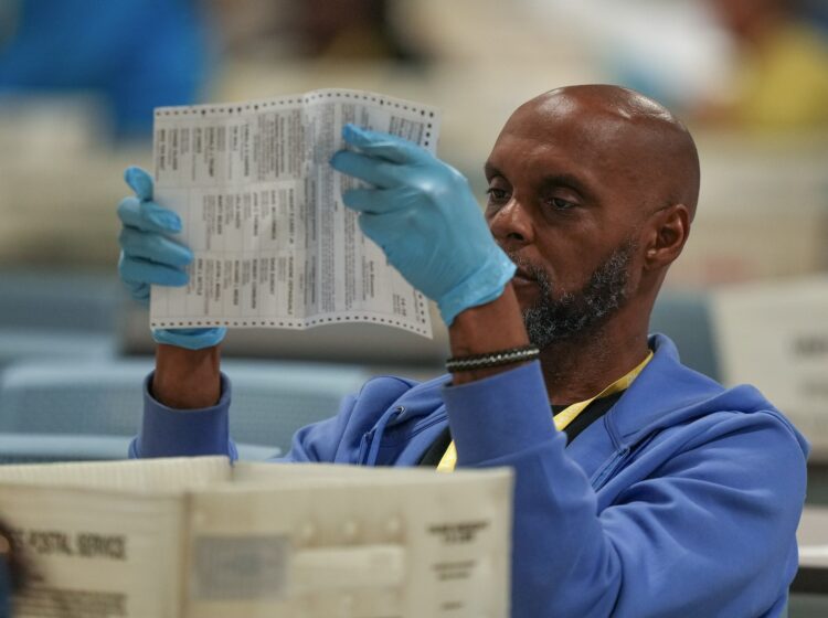 An election worker processes mail ballots for the 2024 general election at the Philadelphia election warehouse, Tuesday, Nov. 5, 2024, in Philadelphia.