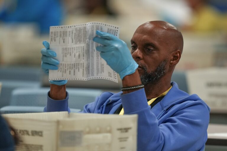 An election worker processes mail ballots for the 2024 general election at the Philadelphia election warehouse, Tuesday, Nov. 5, 2024, in Philadelphia.