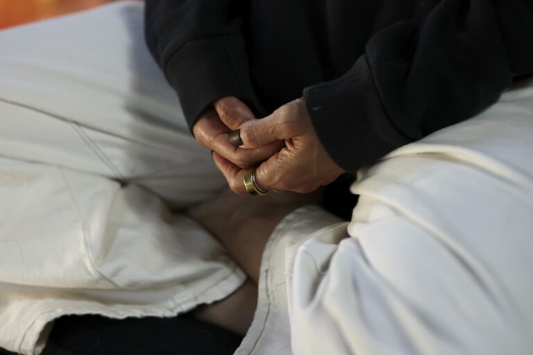 A person's hands clasped