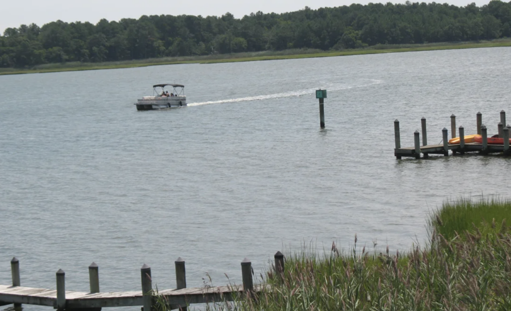 beach-cove-delawARE-inland-bays-j-mussoni a boat driving in the bay