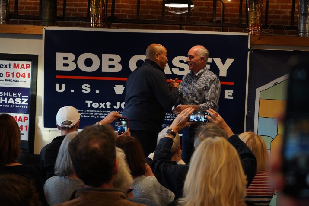 cory-booker-bob-casey-2024-11-04-1 Cory Booker and Bob Casey embrace onstage
