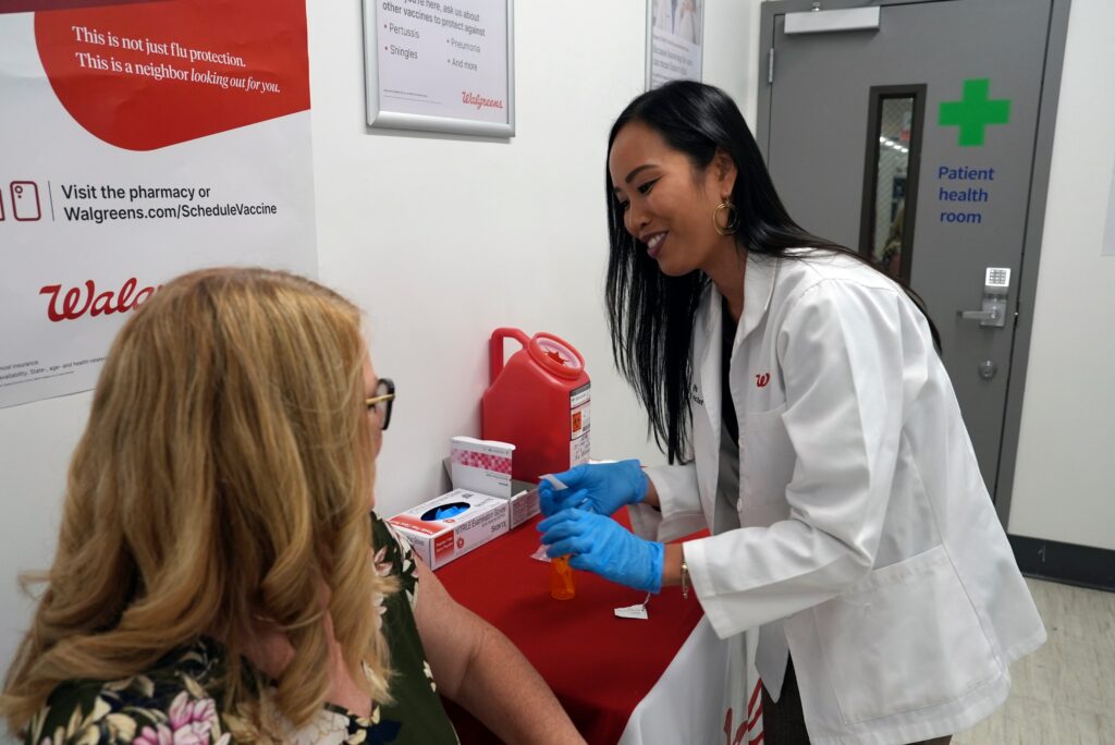 covid-vaccine-2024 Anh Nguyen prepares to administer a COVID-19 vaccine