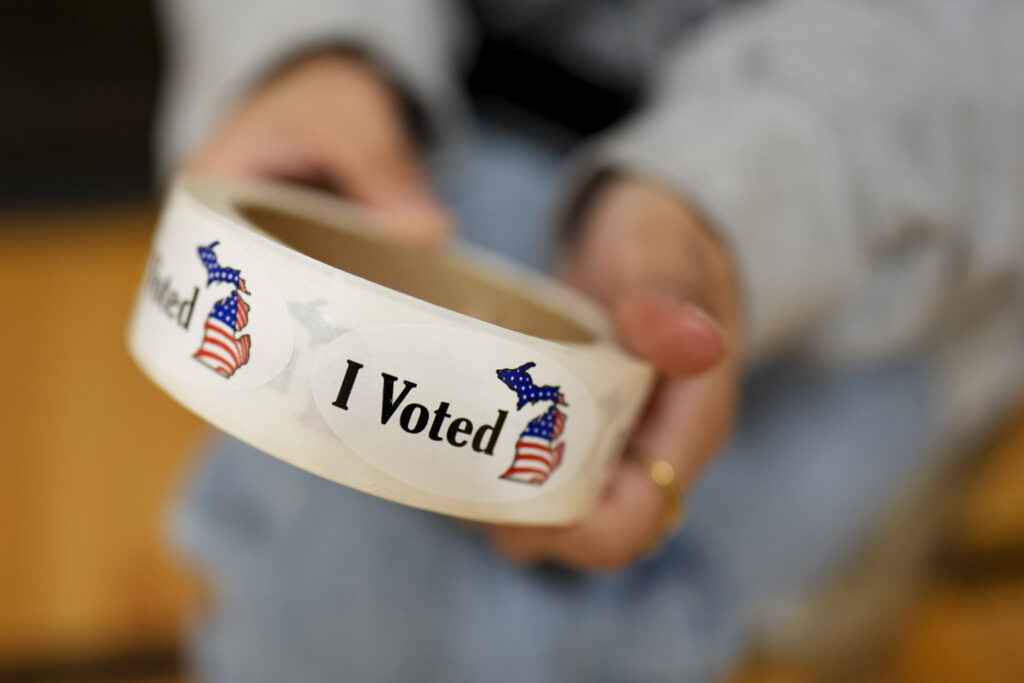 Election 2024 America Votes Michigan A poll worker holds a roll of