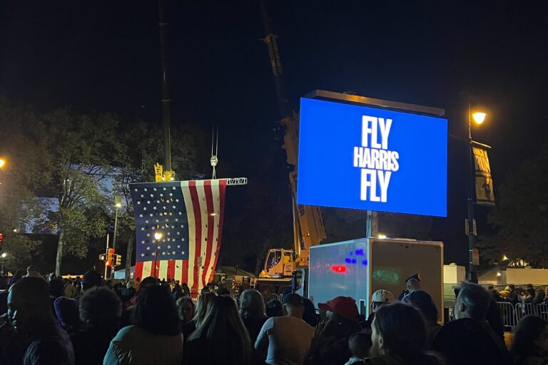 the crowd, and a signs reads FLY HARRIS FLY