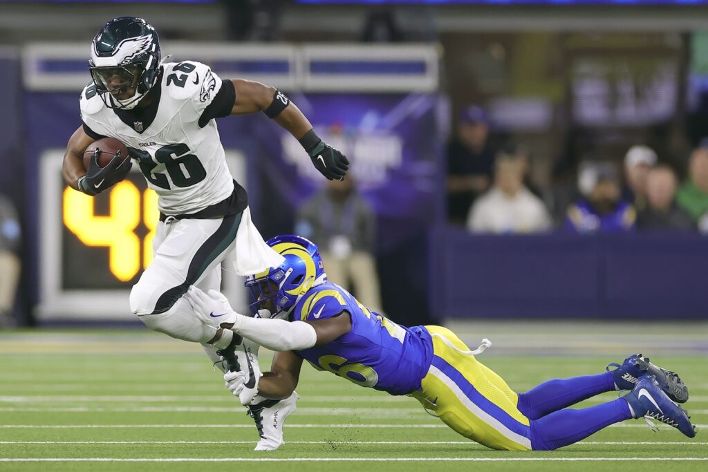Saquon Barkley,Kamren Kinchens agles running back Saquon Barkley, left, runs against Los Angeles Rams safety Kamren Kinchens during the first half of an NFL football game in Inglewood, Calif., Sunday, Nov. 24, 2024.