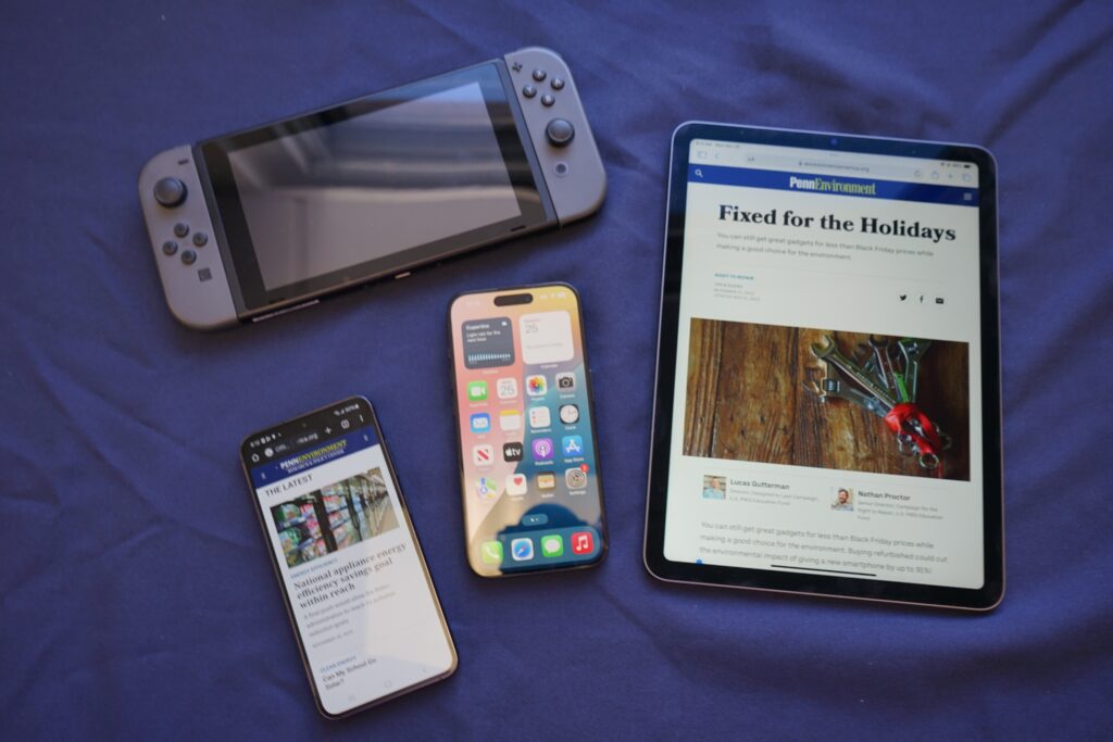 refurbished-electronics-pennenvironment two phones, a tablet and a gaming device on a table