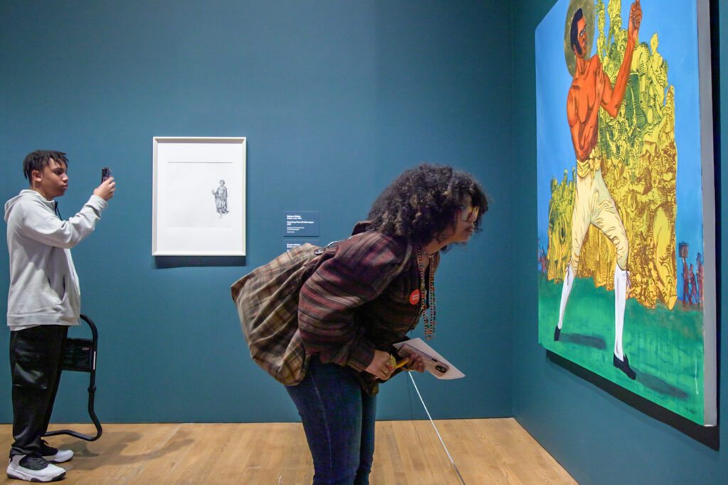 12-13-2024-k-paynter-free-museum-busing-4 students looking at pieces of art at the museum