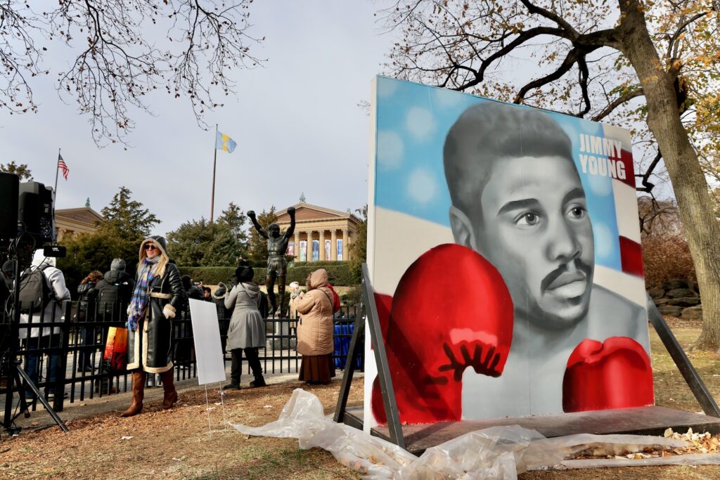A large portrait of Jimmy Young holding up his boxing gloves