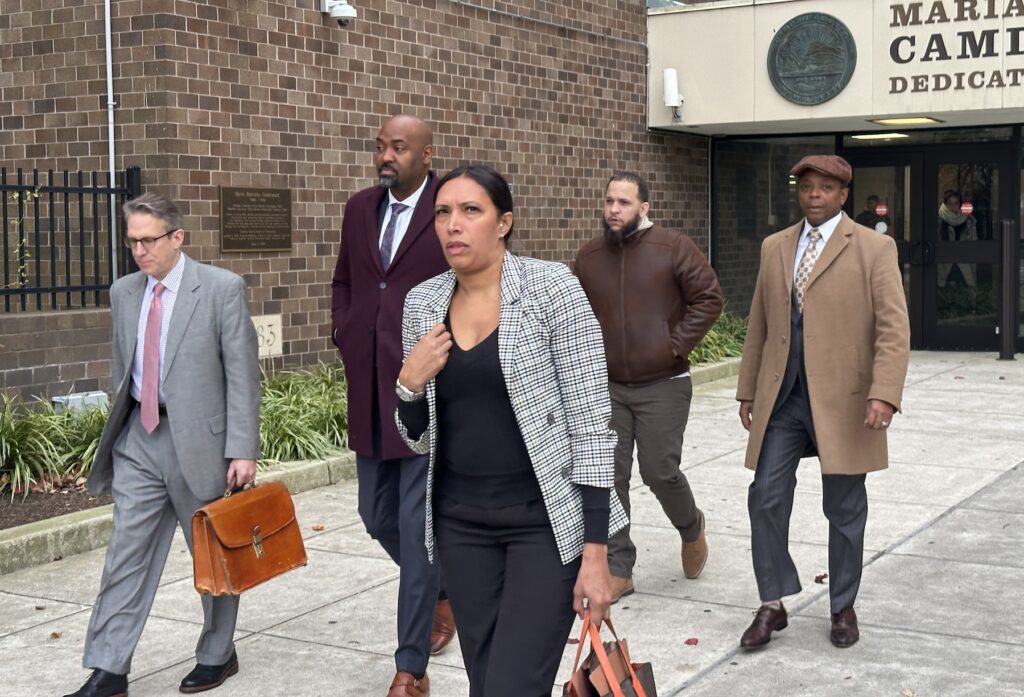 2024 12 09 k burns-camden city councilman arthur barclay leaves court house with attorney shawn huber and former school board pres wasim muhammad_01 A group of people walking out of a courthouse
