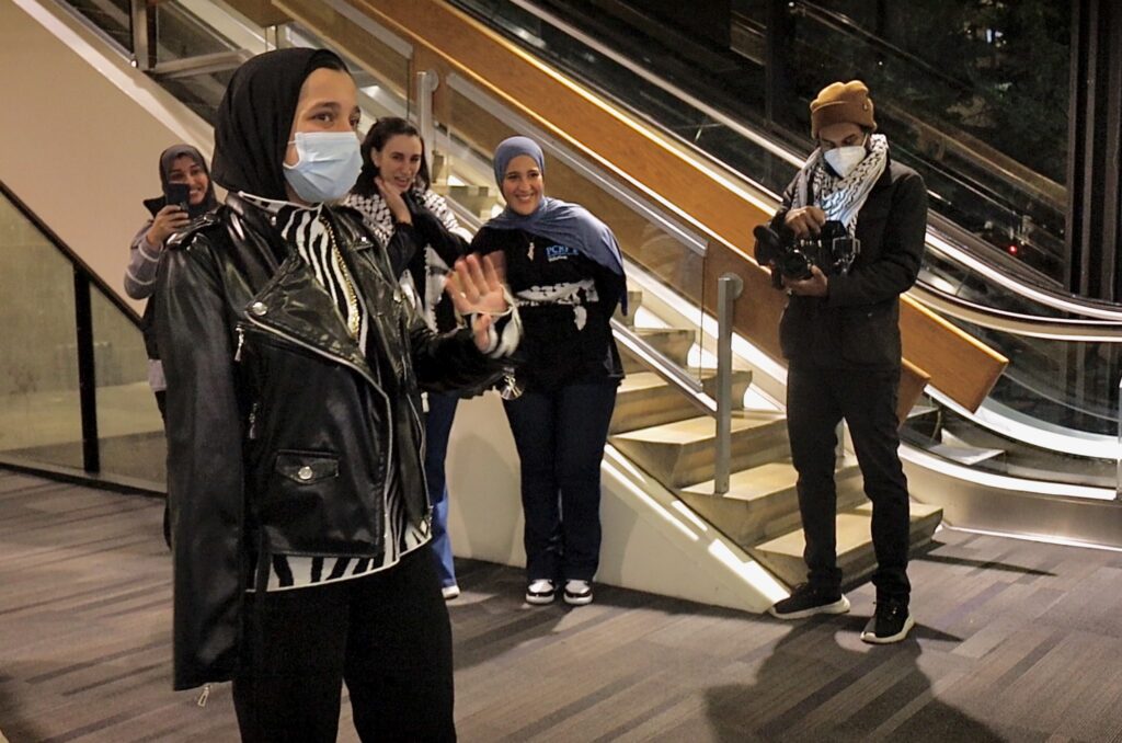 2024 12 15-c russell sluchansky-tasneem abbas-philadelphia international airport-palestinian refugee Tasneem Abbas waving to people after arriving at the airport