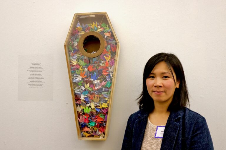 Anh Ly stands next to her sculpture