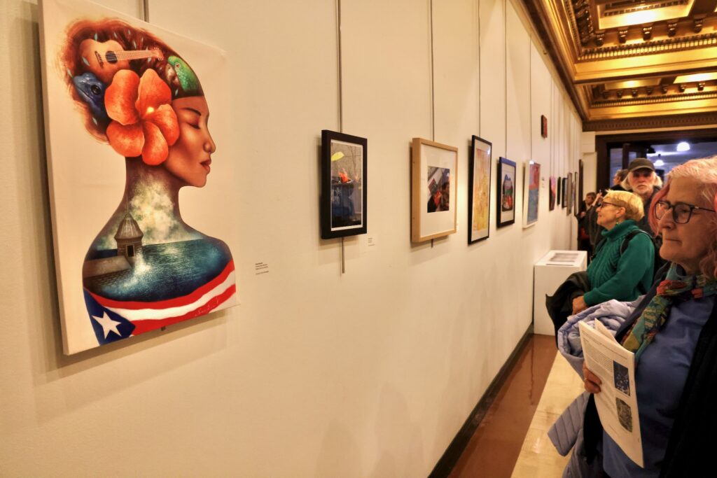 Visitors look at art