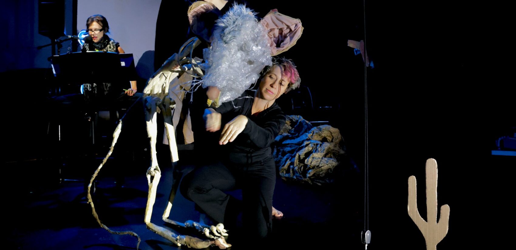 Dancers bring a skeletal packrat to life