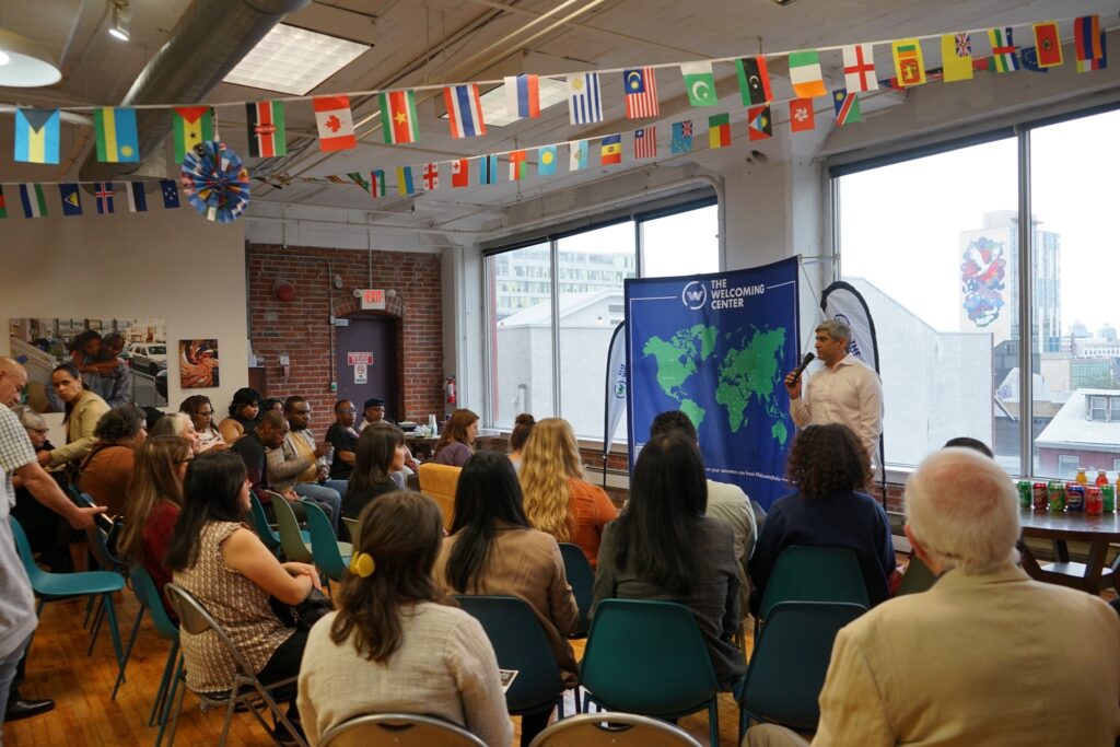 438031825_820108566811319_2191034936286579769_n Anuj Gupta, CEO of The Welcoming Center, speaks to a group of people at the center's office in Philadelphia. (Courtesy of The Welcoming Center)