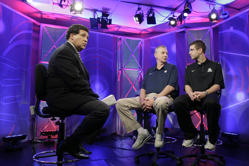 Obit-Greg Gumbel FILE - Greg Gumbel, left, watches as Connecticut head coach Jim Calhoun talks to Butler head coach Brad Stevens, right, prior to taping a television interview for the men's NCAA Final Four college basketball championship game Sunday, April 3, 2011, in Houston. (AP Photo/Eric Gay, File)