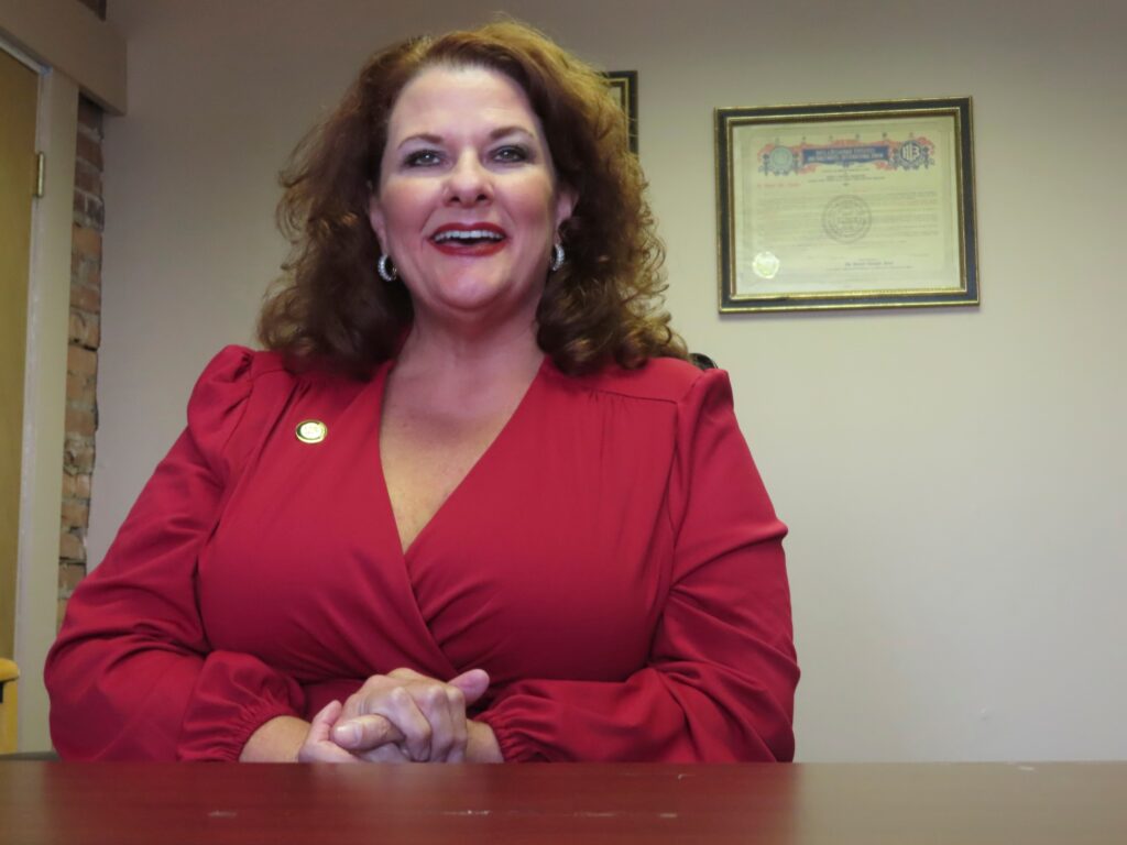 Donna-DeCaprio-2023-07-17 Donna DeCaprio sits and smiles